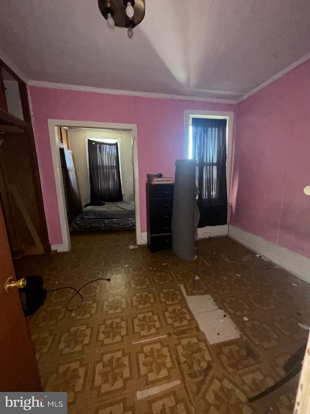 interior space with baseboards and ornamental molding