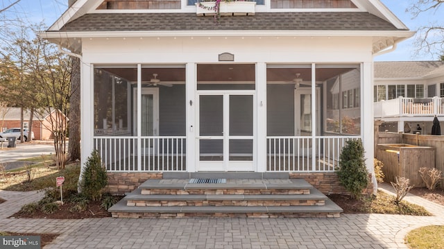 entrance to property featuring mansard roof, roof with shingles, and ceiling fan