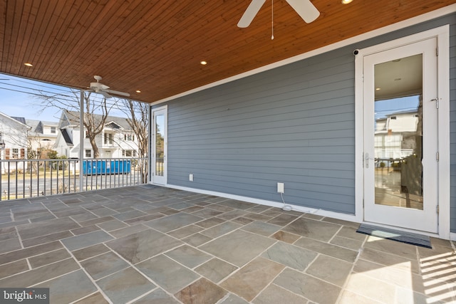 view of patio featuring a ceiling fan and a residential view