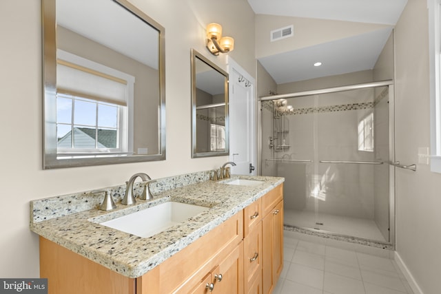 bathroom with visible vents, a stall shower, lofted ceiling, and a sink