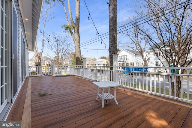 wooden terrace with a residential view