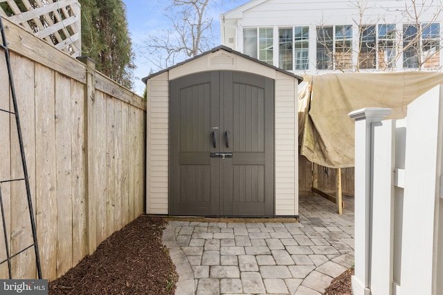 view of shed with fence