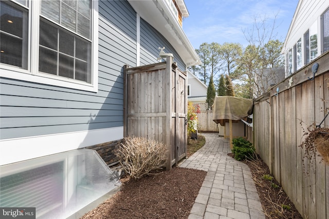 view of side of home featuring a fenced backyard