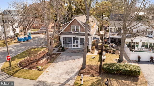 view of front of home with a balcony, fence, and a residential view