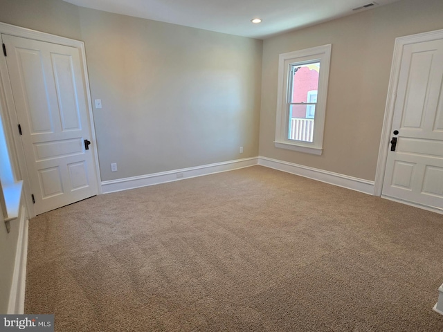 spare room featuring recessed lighting, visible vents, baseboards, and carpet flooring