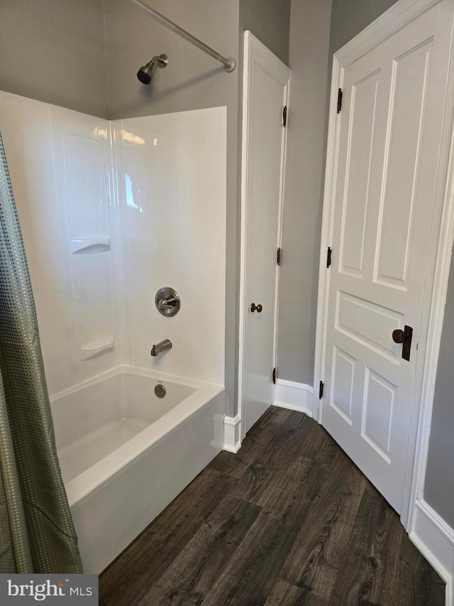 bathroom with wood finished floors and shower / bath combination with curtain