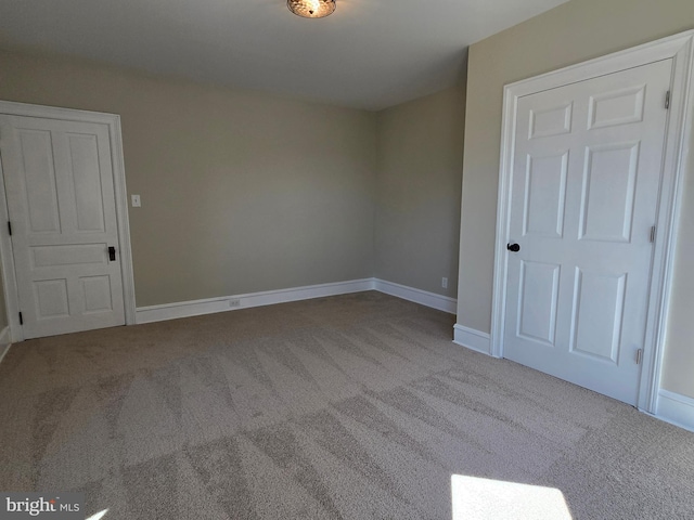 unfurnished room featuring baseboards and carpet flooring