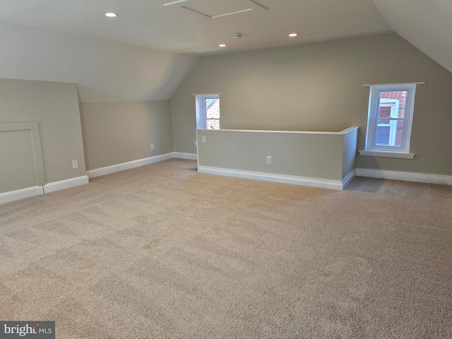 additional living space with carpet flooring, recessed lighting, baseboards, and lofted ceiling