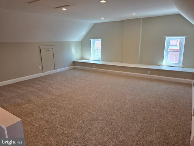 additional living space with lofted ceiling, recessed lighting, baseboards, and light carpet