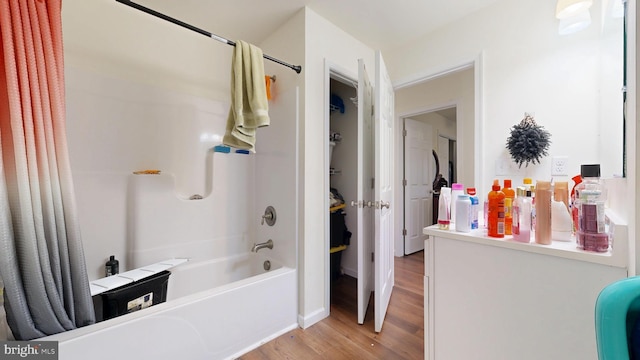 bathroom with shower / bathing tub combination and wood finished floors