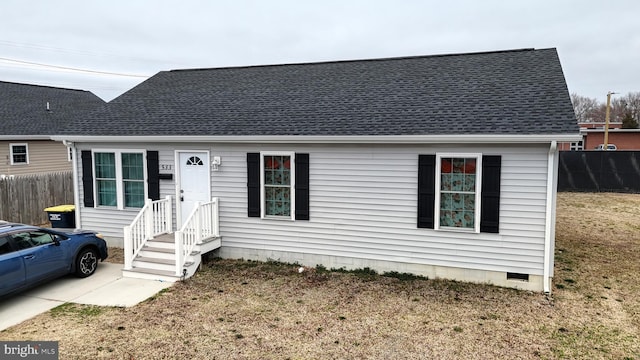 view of front of house featuring crawl space, a shingled roof, and fence