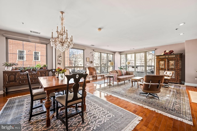 dining room with plenty of natural light, wood finished floors, and visible vents