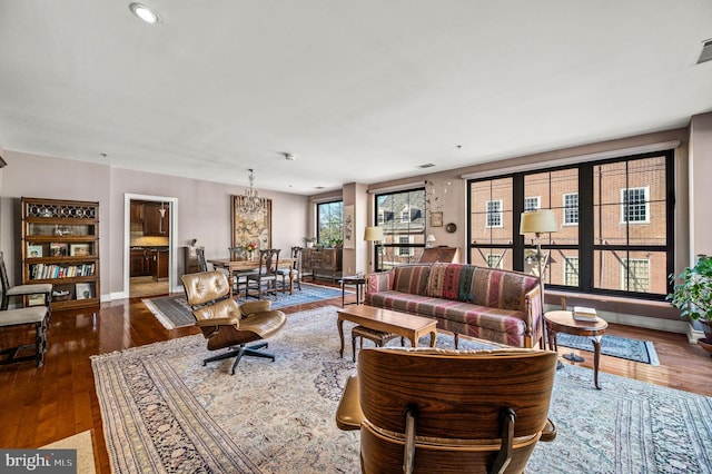 living area with visible vents, baseboards, and wood finished floors