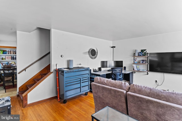 living area featuring stairway and light wood-style floors