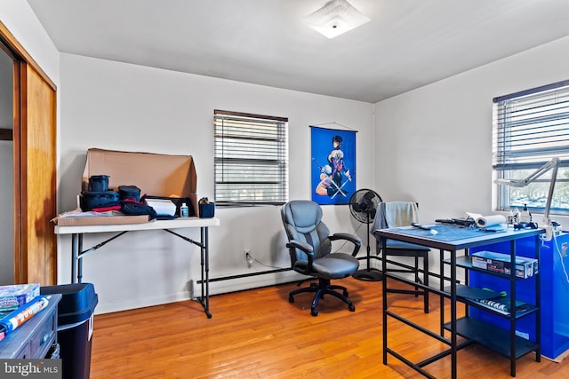 office area featuring a baseboard radiator and wood finished floors