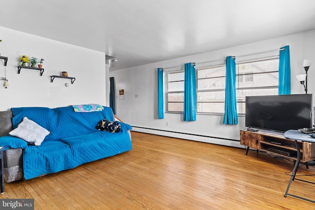 living room featuring baseboard heating and wood-type flooring