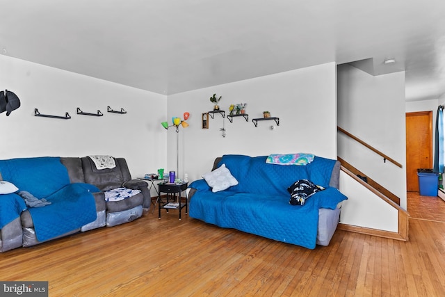 living room with stairway and hardwood / wood-style flooring