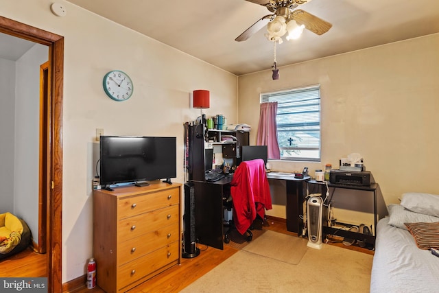 bedroom featuring wood finished floors and a ceiling fan