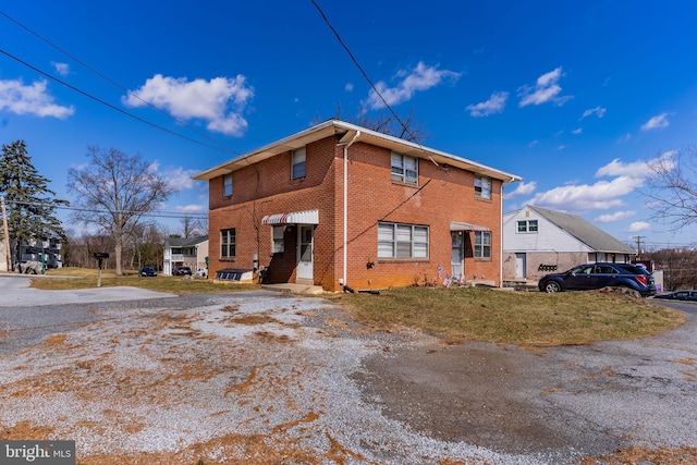 exterior space with a yard and brick siding