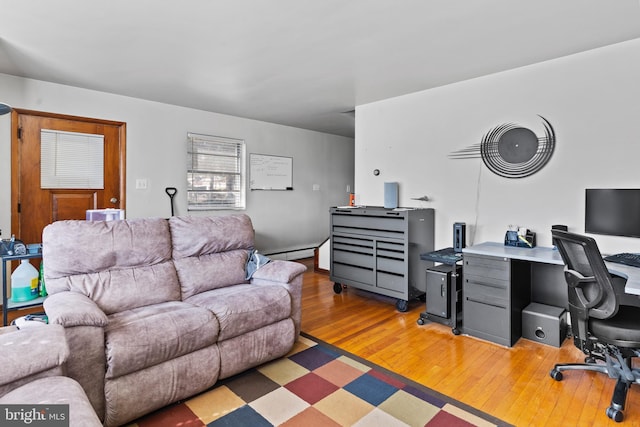 office space featuring baseboard heating and light wood finished floors