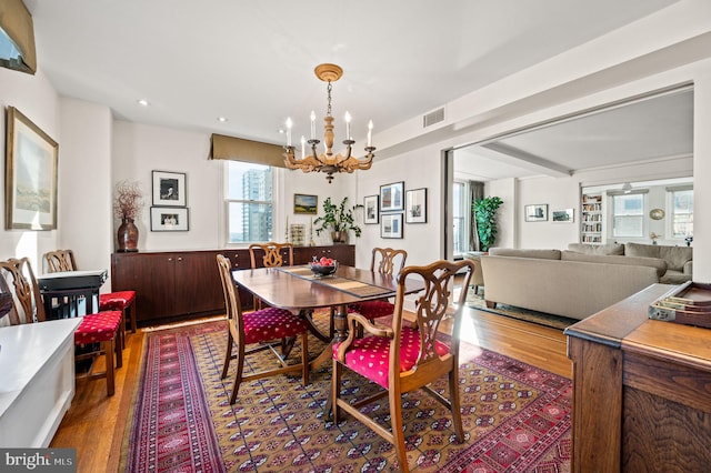 dining area with recessed lighting, visible vents, a notable chandelier, and dark wood finished floors