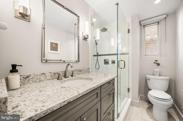 full bathroom with toilet, marble finish floor, a stall shower, baseboards, and vanity