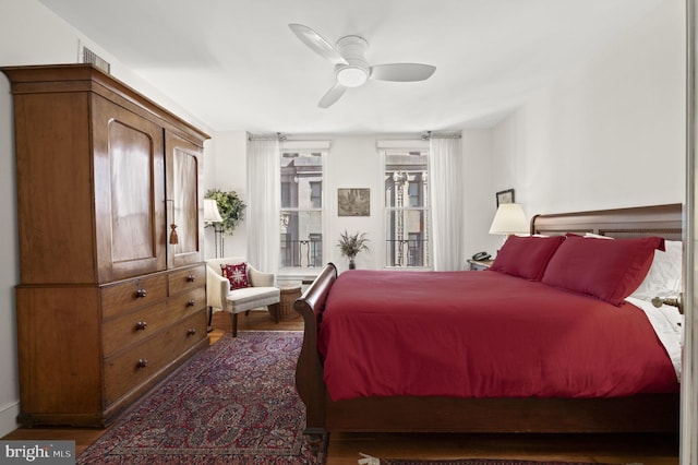 bedroom with visible vents, ceiling fan, and wood finished floors