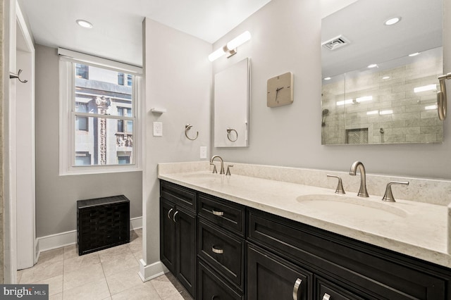 full bathroom with tile patterned flooring, double vanity, visible vents, and a sink