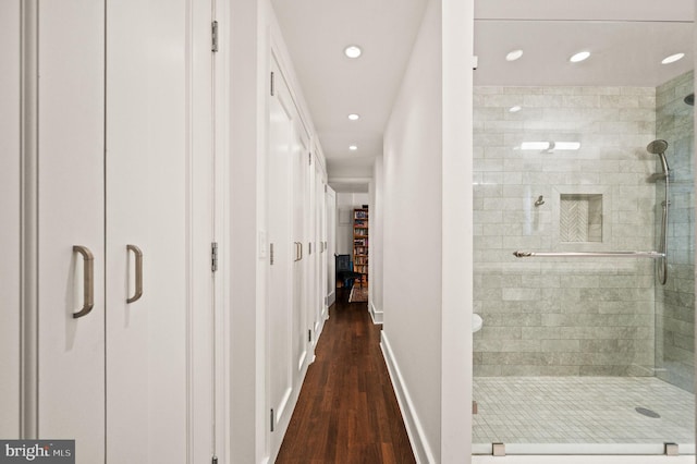 hall with dark wood-style floors, recessed lighting, and baseboards