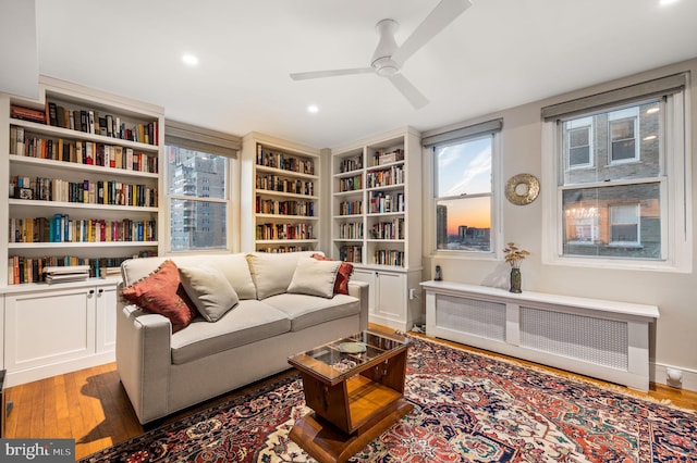 sitting room with recessed lighting, light wood-style flooring, radiator heating unit, and ceiling fan