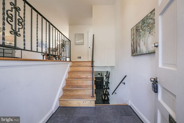 stairs with visible vents and baseboards