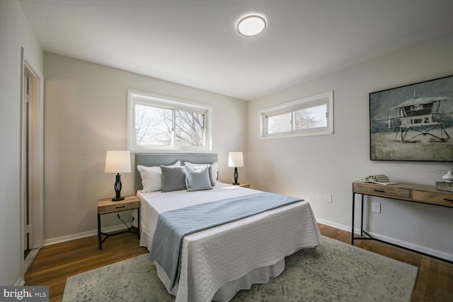 bedroom featuring baseboards and wood finished floors