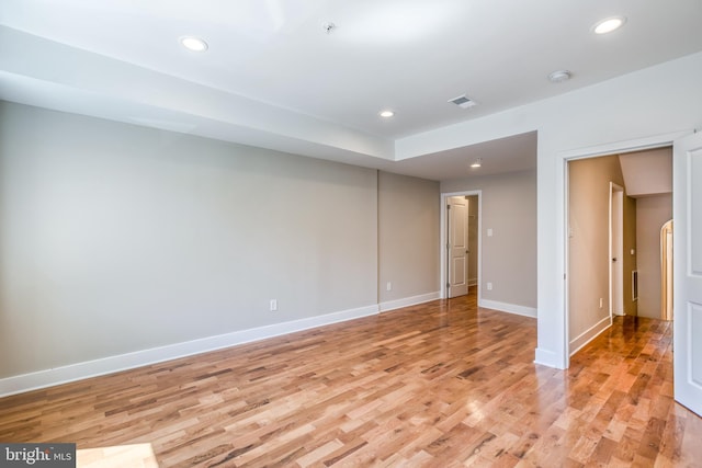 spare room with recessed lighting, light wood-type flooring, and baseboards