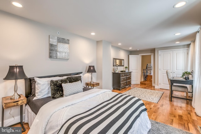 bedroom with light wood finished floors, recessed lighting, and baseboards