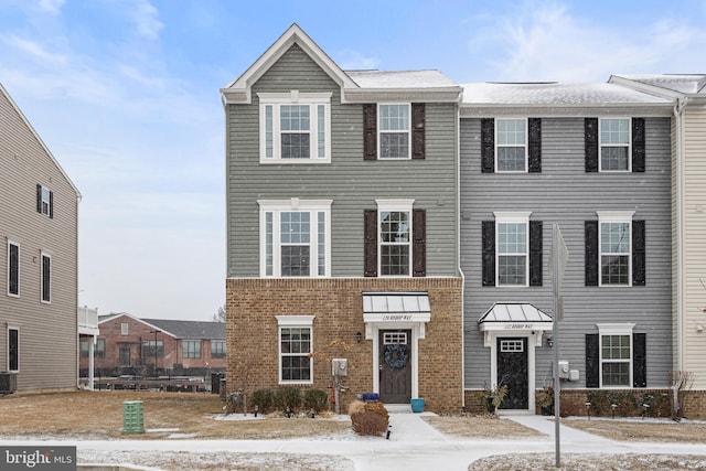 multi unit property featuring brick siding and central AC unit