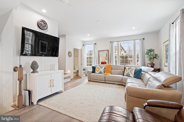 living room featuring light wood finished floors and recessed lighting