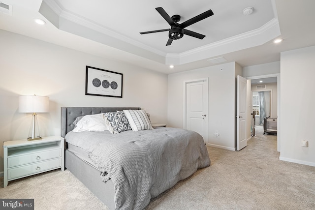 carpeted bedroom with ornamental molding, a ceiling fan, a tray ceiling, recessed lighting, and baseboards