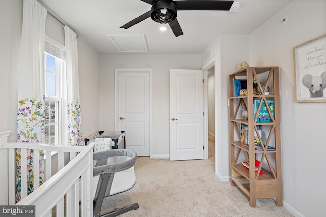 bedroom with visible vents, baseboards, light colored carpet, and attic access