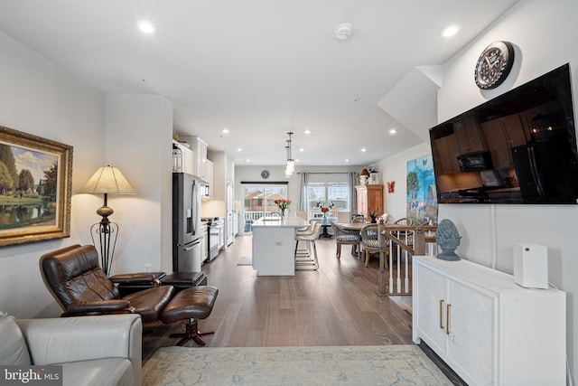 living room with recessed lighting and wood finished floors