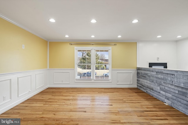 unfurnished room featuring recessed lighting, ornamental molding, and wood finished floors