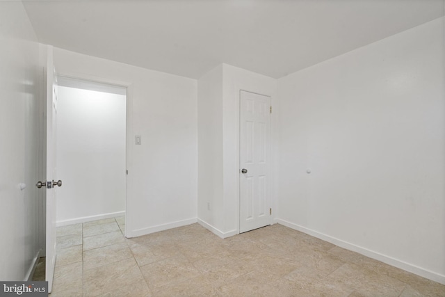 empty room featuring baseboards