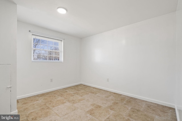 spare room featuring baseboards