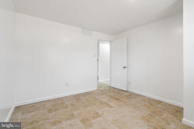 spare room with baseboards