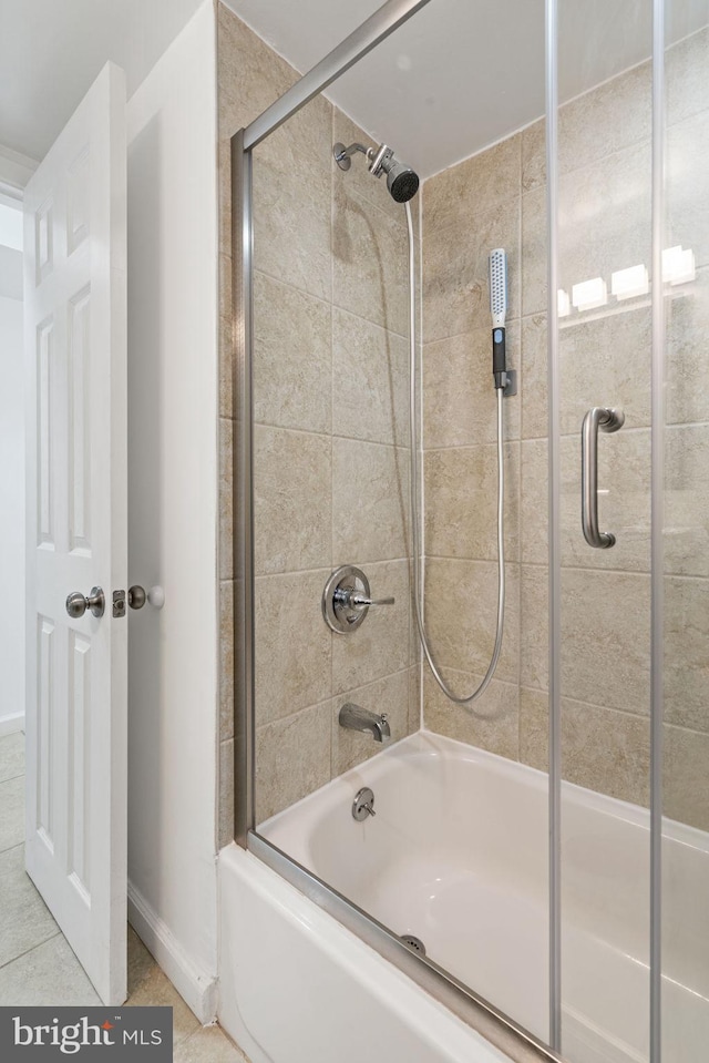 full bathroom featuring bath / shower combo with glass door and tile patterned flooring