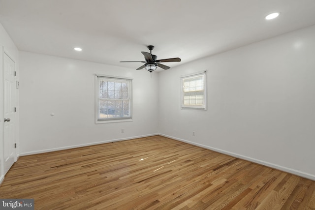 spare room featuring recessed lighting, baseboards, and light wood-style flooring