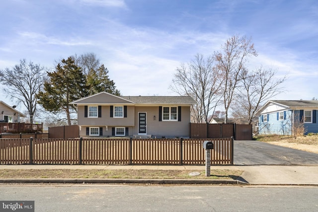 view of front of home with a fenced front yard and driveway