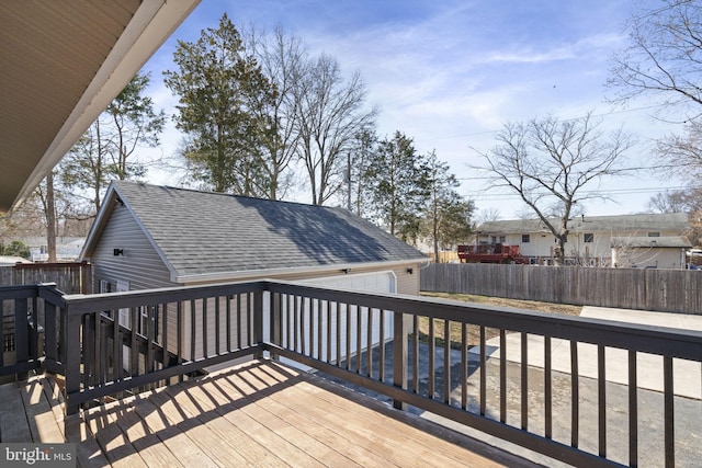 wooden deck with a garage and fence