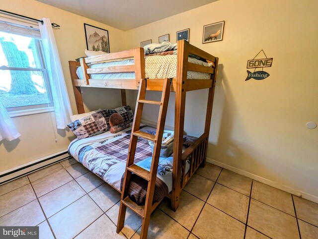 tiled bedroom featuring baseboards and a baseboard radiator