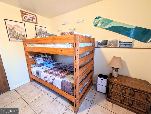 tiled bedroom featuring baseboards