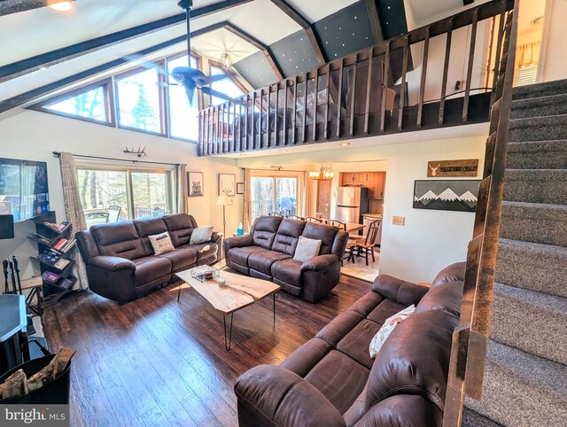 living room featuring stairway, high vaulted ceiling, beamed ceiling, and hardwood / wood-style flooring